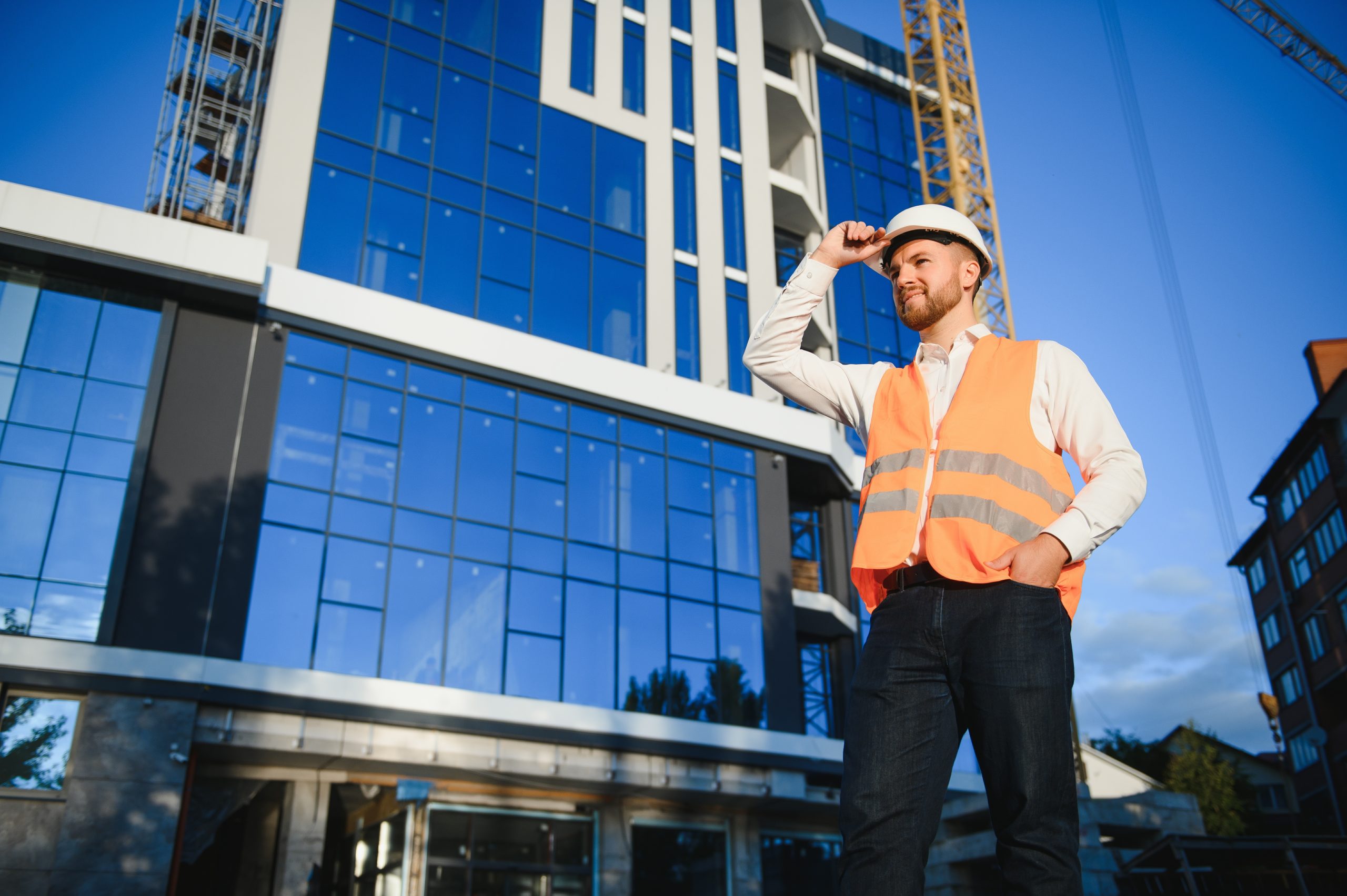 Architect in helmet near new building